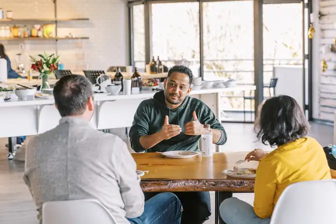 A group speaking while eating lunch